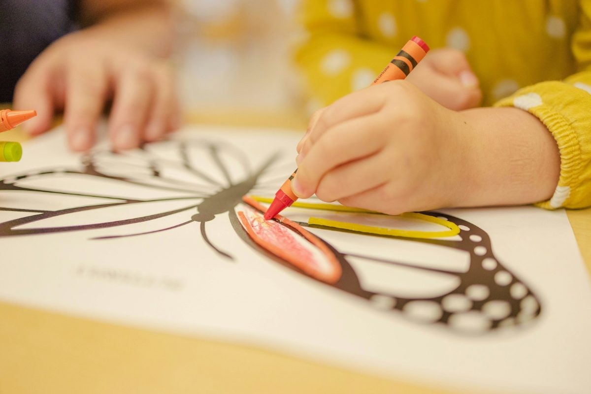 クレヨンで塗り絵をする子ども